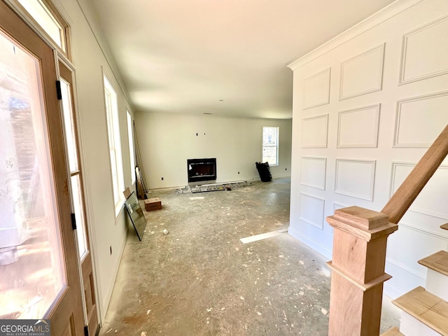 unfurnished living room featuring a fireplace and stairs