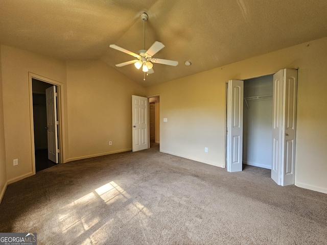 unfurnished bedroom with a textured ceiling, ceiling fan, carpet floors, a closet, and lofted ceiling