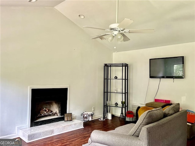 living room with ceiling fan, dark hardwood / wood-style floors, and vaulted ceiling