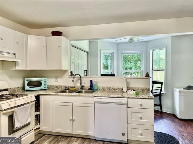 kitchen featuring white cabinetry, sink, dark wood-type flooring, and white appliances