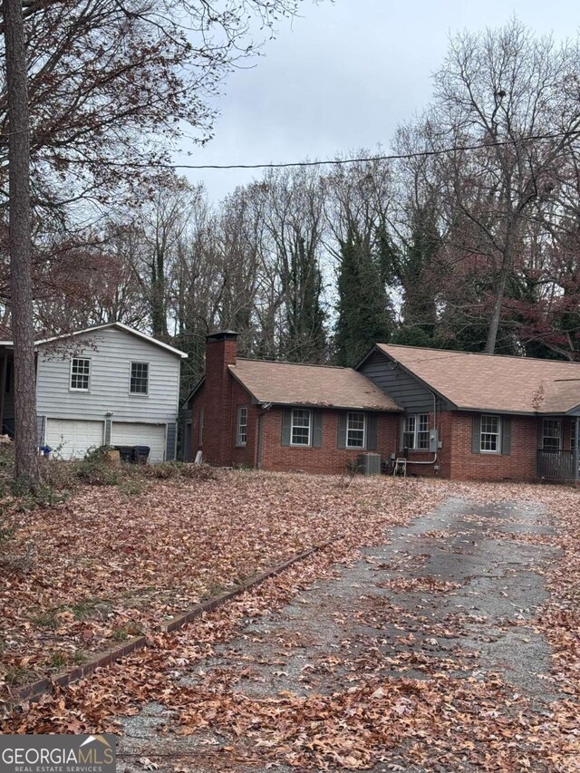 view of front facade with central AC and a garage