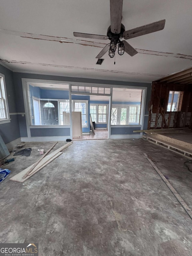 unfurnished living room featuring ceiling fan