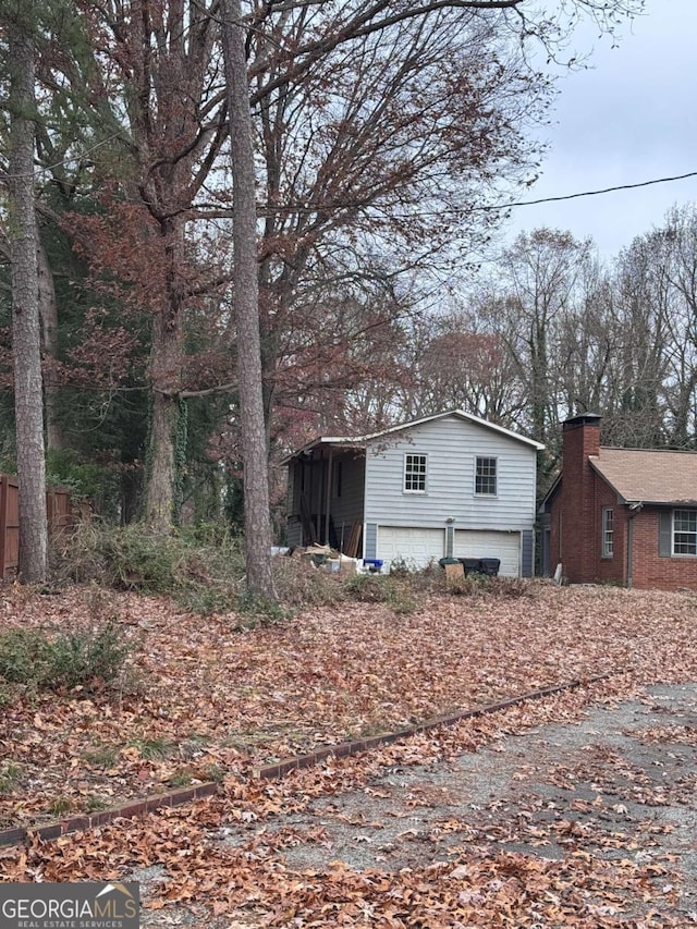 view of side of home featuring a garage