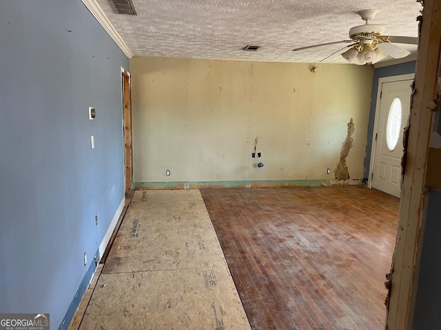 entrance foyer featuring a textured ceiling, ceiling fan, and crown molding