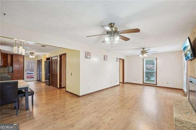 living room featuring a textured ceiling and light hardwood / wood-style floors