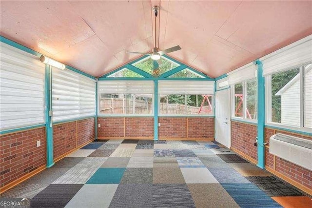 unfurnished sunroom with lofted ceiling, ceiling fan, and a healthy amount of sunlight