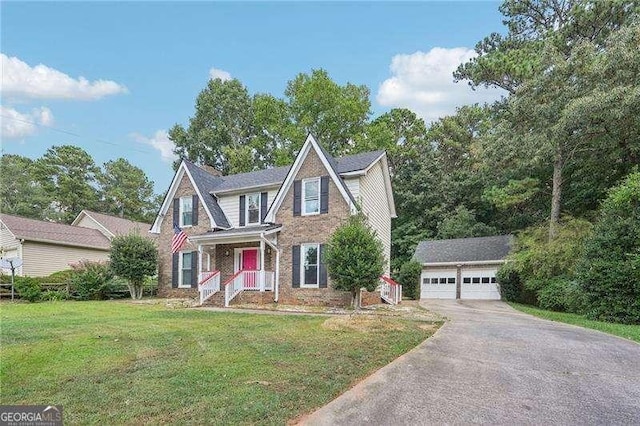 view of front facade featuring a garage, an outbuilding, and a front lawn