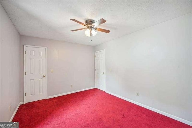 carpeted empty room featuring a textured ceiling and ceiling fan