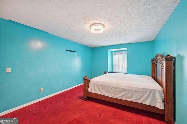 bedroom featuring carpet floors and a textured ceiling