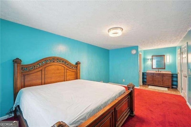 bedroom with carpet and a textured ceiling