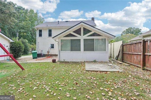 back of property featuring central AC unit, a sunroom, a yard, and a patio