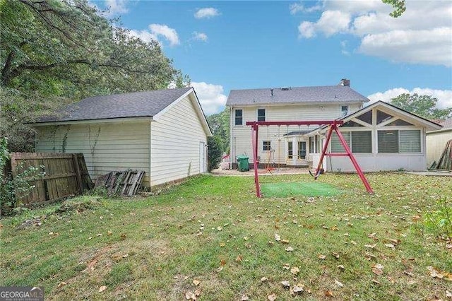 back of house featuring a lawn