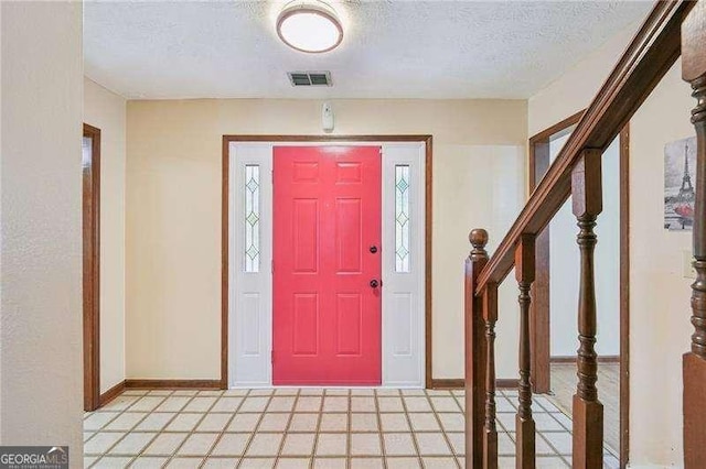 foyer with plenty of natural light and a textured ceiling