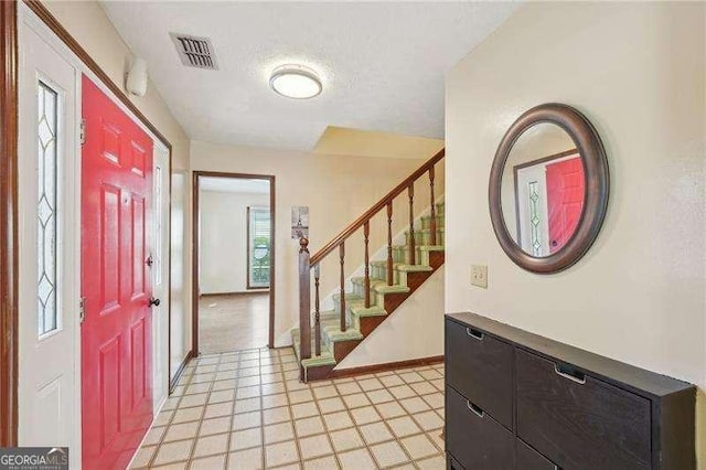 foyer entrance featuring a textured ceiling