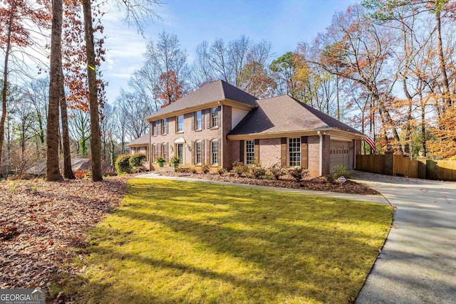 view of front facade with a garage and a front lawn