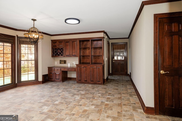 kitchen with dark brown cabinetry, ornamental molding, pendant lighting, and an inviting chandelier