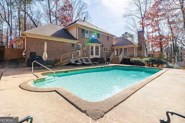 view of pool with area for grilling, a patio area, and a wooden deck