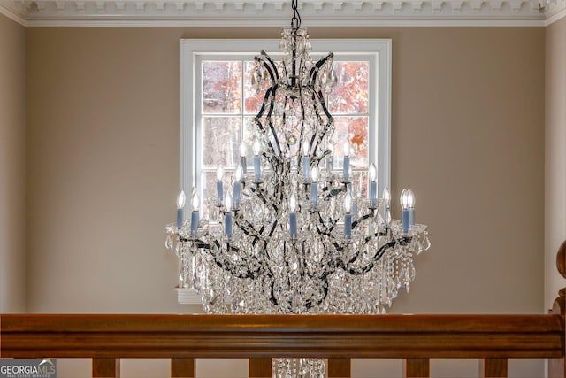 interior details featuring an inviting chandelier and crown molding