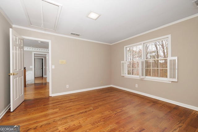 unfurnished room with hardwood / wood-style flooring and ornamental molding