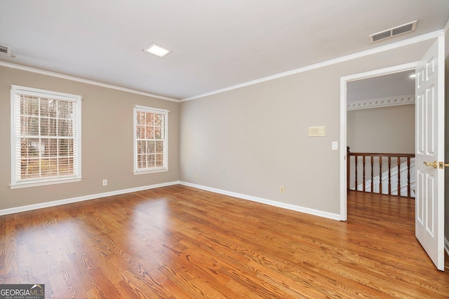 unfurnished room with light wood-type flooring and crown molding