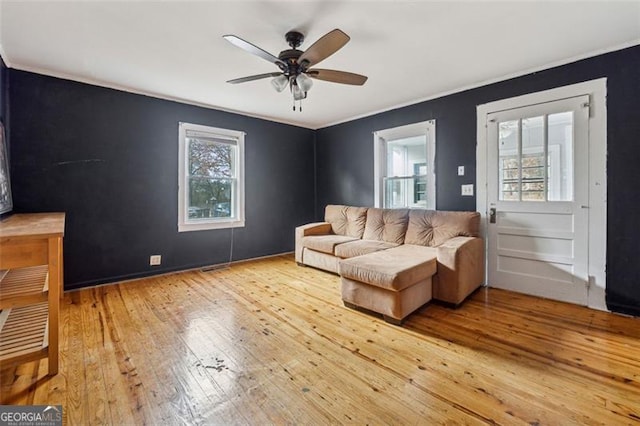 living room with a wealth of natural light, ceiling fan, and hardwood / wood-style flooring