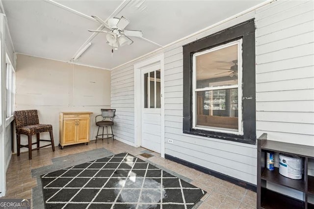 interior space with ceiling fan