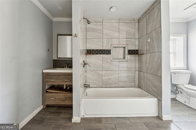 full bathroom featuring vanity, toilet, crown molding, and tiled shower / bath