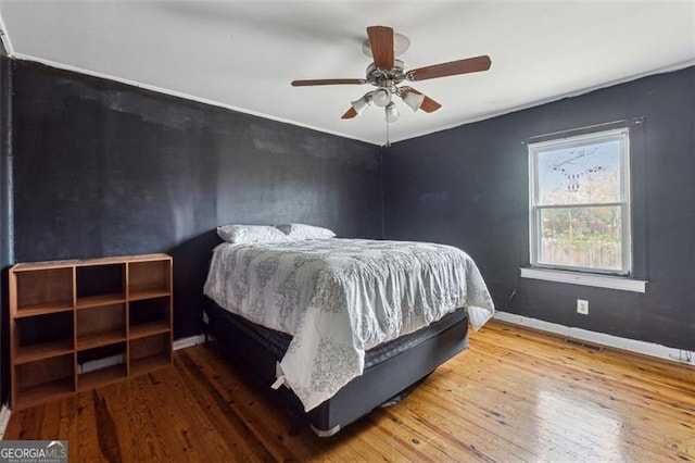 bedroom featuring ceiling fan and wood-type flooring