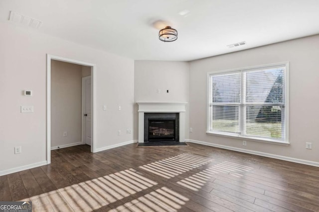 unfurnished living room featuring dark hardwood / wood-style flooring