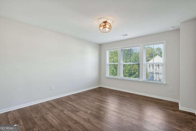 empty room with dark hardwood / wood-style floors