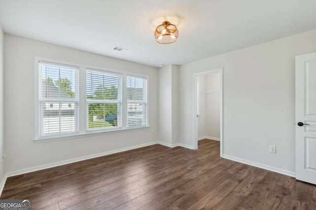 empty room featuring dark hardwood / wood-style flooring