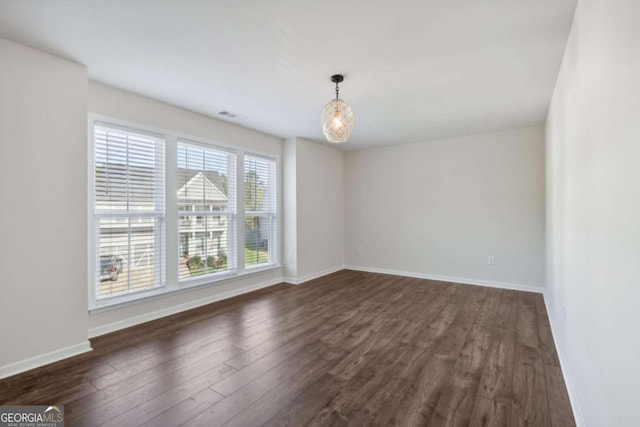 spare room with dark wood-type flooring