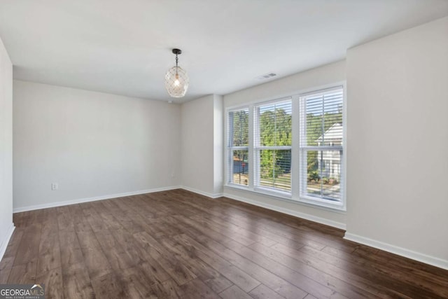 empty room with dark hardwood / wood-style flooring