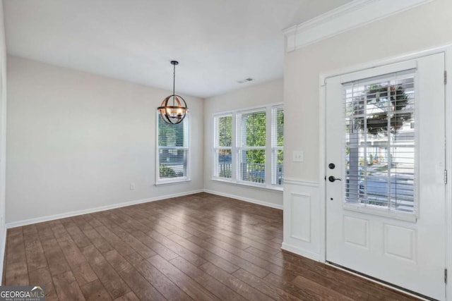 foyer featuring a chandelier and dark hardwood / wood-style floors