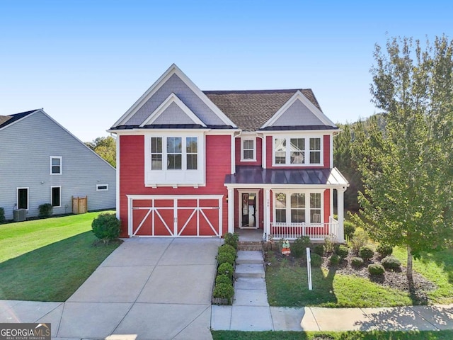 view of front of home featuring central AC unit, covered porch, a front yard, and a garage