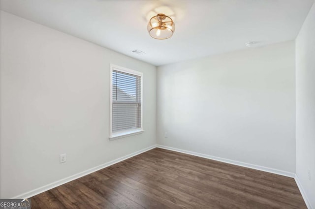 unfurnished room featuring dark hardwood / wood-style flooring