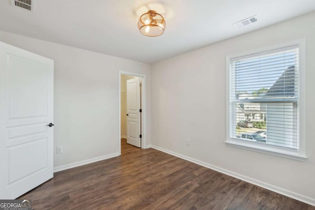 spare room with dark hardwood / wood-style floors