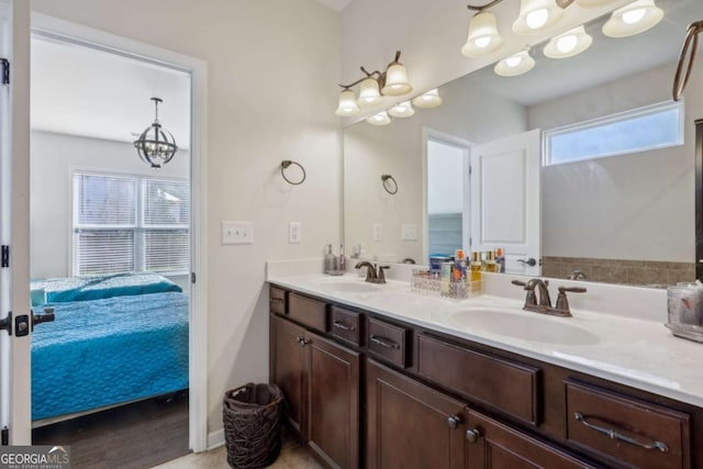 bathroom featuring plenty of natural light, vanity, and a chandelier