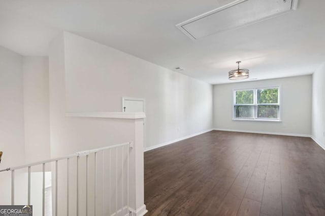 empty room with dark hardwood / wood-style flooring