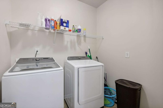 clothes washing area with washer and clothes dryer