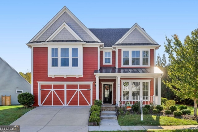 craftsman-style house featuring a front lawn and a garage