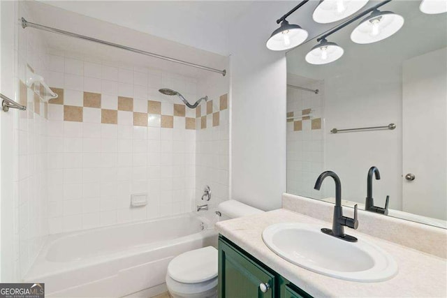 full bathroom featuring vanity, toilet, and tiled shower / bath combo