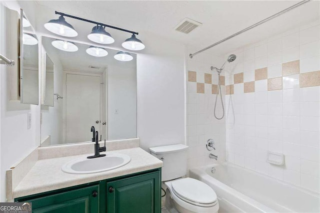 full bathroom featuring vanity, toilet, and tiled shower / bath combo