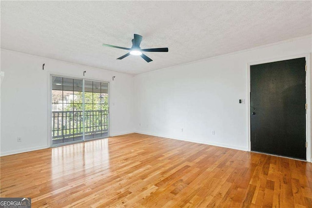 spare room featuring a textured ceiling, light hardwood / wood-style floors, and ceiling fan