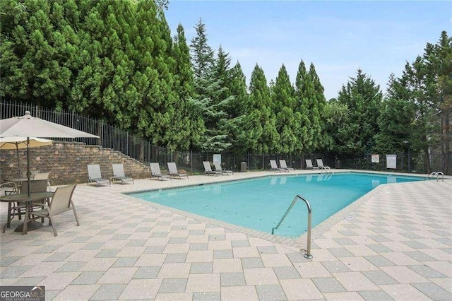 view of swimming pool with a patio