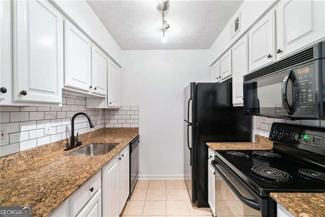 kitchen with a textured ceiling, sink, black appliances, dark stone countertops, and white cabinets