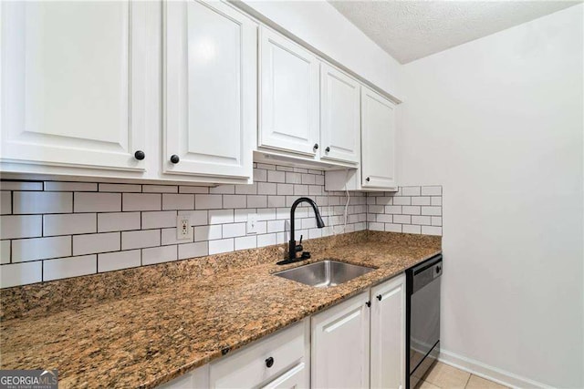 kitchen with white cabinetry, sink, dishwasher, backsplash, and dark stone countertops