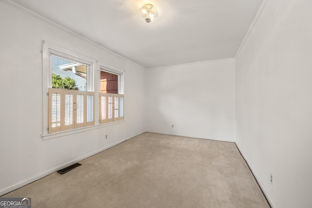 carpeted spare room featuring ornamental molding