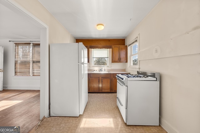 kitchen with white appliances and sink