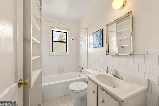 full bathroom featuring tile walls, tiled shower / bath combo, vanity, tile patterned flooring, and toilet